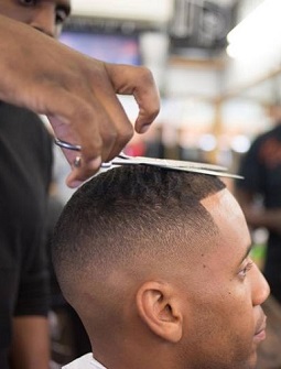 Reggie Yates tends to get a 1.5 cut, going with the grain, and a medium to high skin fade